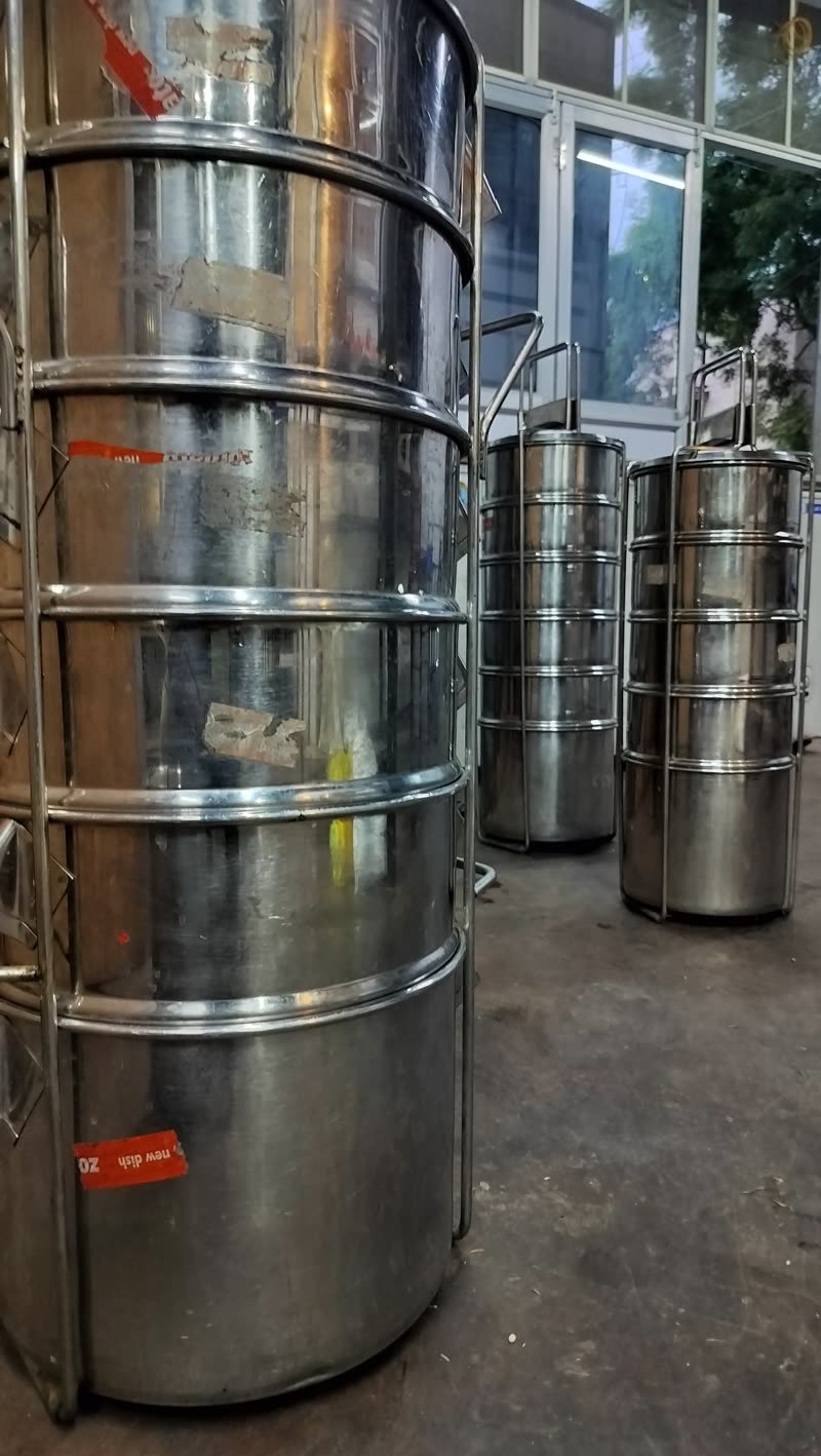 Tiffin carriers lined up at the door before delivery